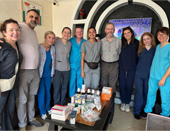 Orthodontist volunteering on dental charity mission providing free dental care